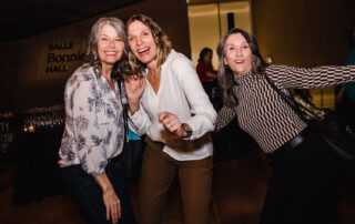 Women Wine & Food Event - Women's Health Clinic - Amanda Douglas Events - three women dancing and laughing